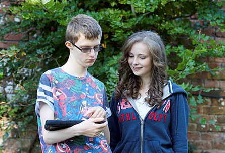 Two people looking at a tablet